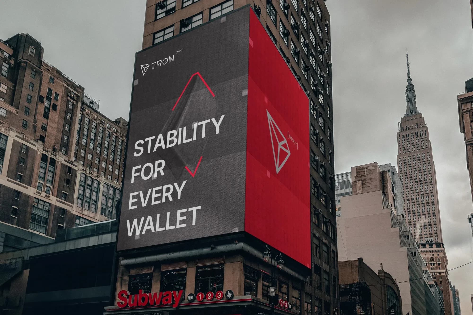 A tall city billboard reading Stability for Every Wallet beside a red TRON panel.